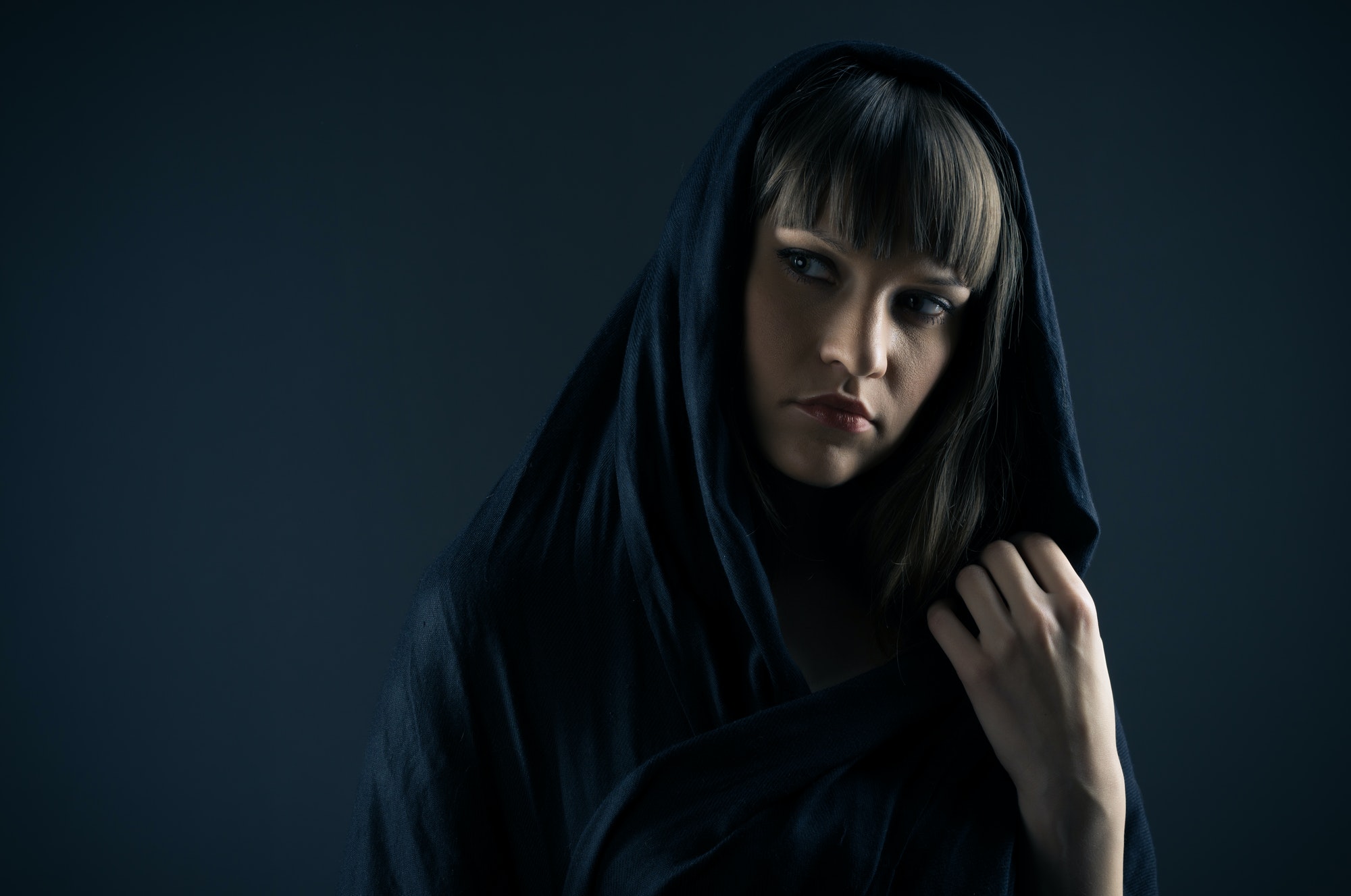 mysterious lady standing against blue background 1